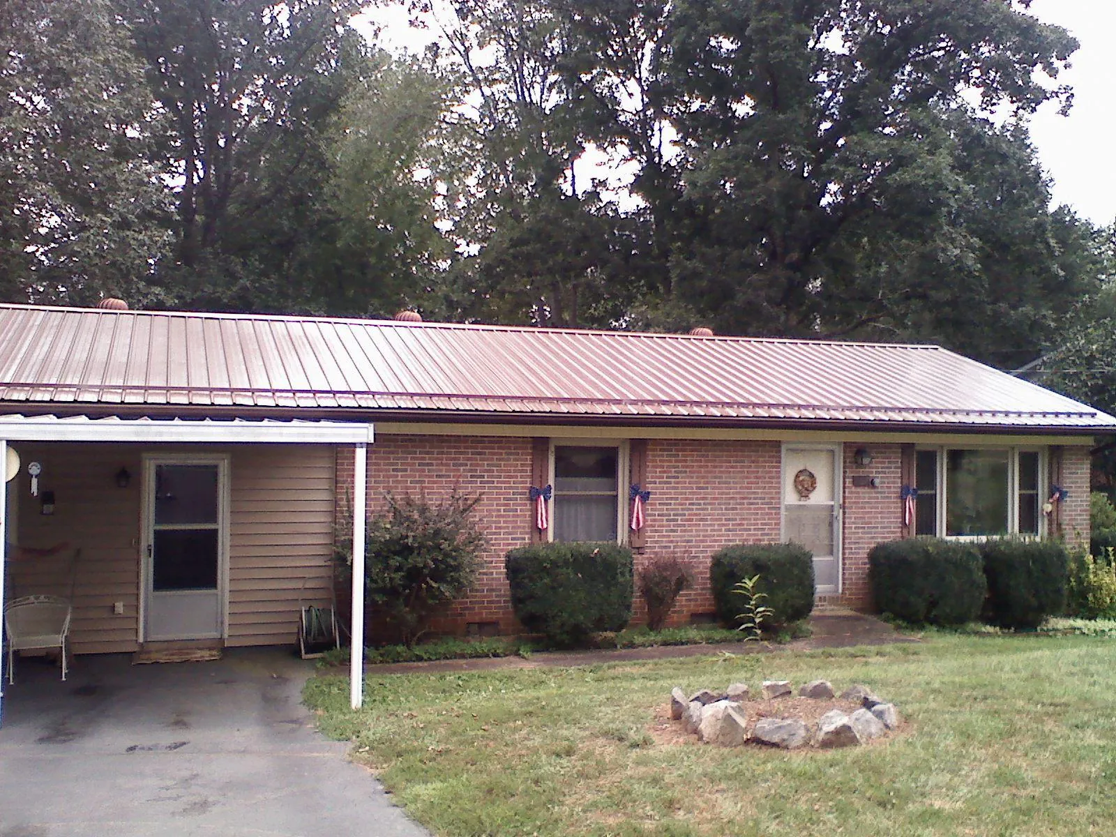 Bronze metal roof and carport on a brick ranch home — Roof Repair work by our crew in Rehoboth